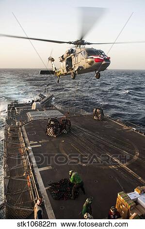 An MH-60S Sea Hawk helicopter delivers cargo to USS Mobile Bay. View Large Photo Image Picture - An MH-60S Sea Hawk helicopter delivers cargo to USS Mobile Bay.. Fotosearch