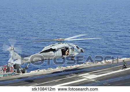 An MH-60S Sea Hawk helicopter lands on the flight deck of USS George H. W. Bush. View Large Photo Image Picture - An MH-60S Sea Hawk helicopter lands on the flight deck of USS George H. W. Bush.. Fotosearch