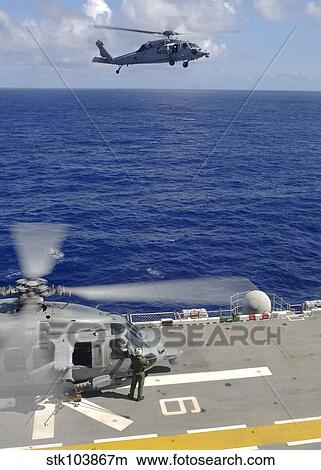 Picture - An MH-60S Sea Hawk helicopter approaches the flight deck of USS Essex.. Fotosearch
