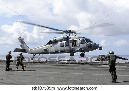 An MH-60S Sea Hawk lands on the flight deck of USS John C. Stennis. View Large Photo Image Picture - An MH-60S Sea Hawk lands on the flight deck of USS John C. Stennis.. Fotosearch