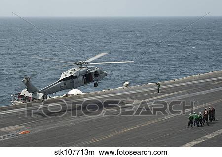 An MH-60S Sea Hawk lands on the flight deck of USS Nimitz. View Large Photo Image Picture - An MH-60S Sea Hawk lands on the flight deck of USS Nimitz.. Fotosearch