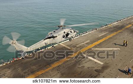 An MH-60S Sea Hawk lands on the flight deck of USS Bonhomme Richard. View Large Photo Image Picture - An MH-60S Sea Hawk lands on the flight deck of USS Bonhomme Richard.. Fotosearch