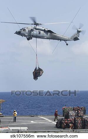 An MH-60S Sea Hawk picks up cargo from USNS Medgar Evers. View Large Photo Image Picture - An MH-60S Sea Hawk picks up cargo from USNS Medgar Evers.. Fotosearch