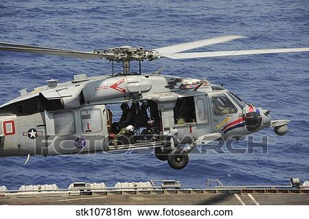 An MH-60S Sea Hawk prepares to land on the flight deck of USS Nimitz. View Large Photo Image Picture - An MH-60S Sea Hawk prepares to land on the flight deck of USS Nimitz.. Fotosearch