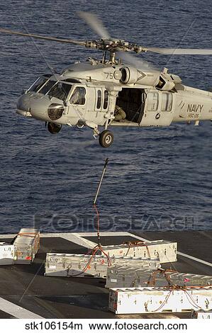 An MH-60S Seahawk delivers ammunition onto the flight deck of USS Theodore Roosevelt. View Large Photo Image Picture - An MH-60S Seahawk delivers ammunition onto the flight deck of USS Theodore Roosevelt.. Fotosearch