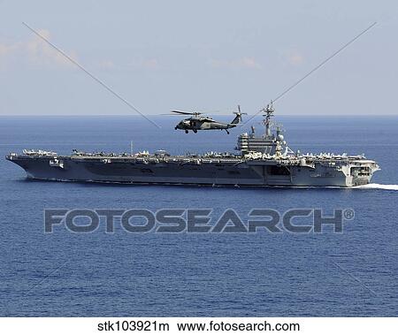 An MH-60S Seahawk helicopter flies over USS George H. W. Bush. View Large Photo Image Picture - An MH-60S Seahawk helicopter flies over USS George H. W. Bush.. Fotosearch