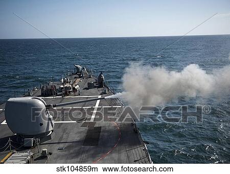 An Mk-45 lightweight gun is fired aboard guided missile destroyer USS Arleigh Burke. View Large Photo Image Picture - An Mk-45 lightweight gun is fired aboard guided missile destroyer USS Arleigh Burke.. Fotosearch
