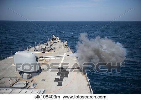 An MK-45 lightweight gun is fired aboard USS Arleigh Burke. View Large Photo Image Picture - An MK-45 lightweight gun is fired aboard USS Arleigh Burke.. Fotosearch