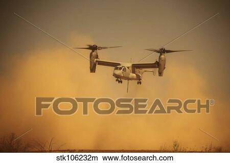 An MV-22 Osprey aircraft blows dust into the air while taking off. View Large Photo Image Picture - An MV-22 Osprey aircraft blows dust into the air while taking off.. Fotosearch