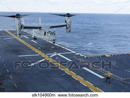 An MV-22 Osprey lands aboard the amphibious assault ship USS Iwo Jima View Large Photo Image Picture - An MV-22 Osprey lands aboard the amphibious assault ship USS Iwo Jima. Fotosearch