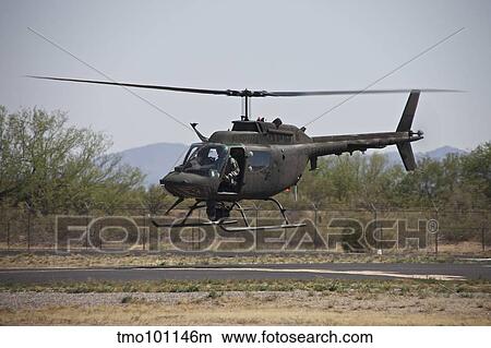 An OH-58 Kiowa helicopter of the U. S. Army landing at Pinal Airpark, Arizona. View Large Photo Image Picture - An OH-58 Kiowa helicopter of the U. S. Army landing at Pinal Airpark, Arizona.. Fotosearch