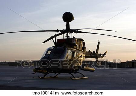 An OH-58D Kiowa during sunset. View Large Photo Image Picture - An OH-58D Kiowa during sunset.. Fotosearch