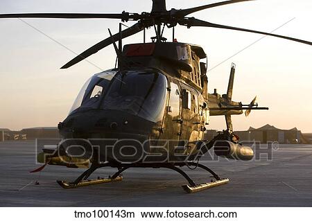 An OH-58D Kiowa during sunset. View Large Photo Image Picture - An OH-58D Kiowa during sunset.. Fotosearch
