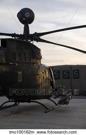 An OH-58D Kiowa helicopter during sunset. View Large Photo Image Picture - An OH-58D Kiowa helicopter during sunset.. Fotosearch