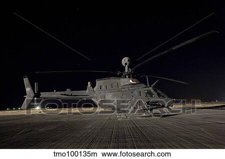 An OH-58D Kiowa sits on its pad at night. View Large Photo Image Picture - An OH-58D Kiowa sits on its pad at night.. Fotosearch