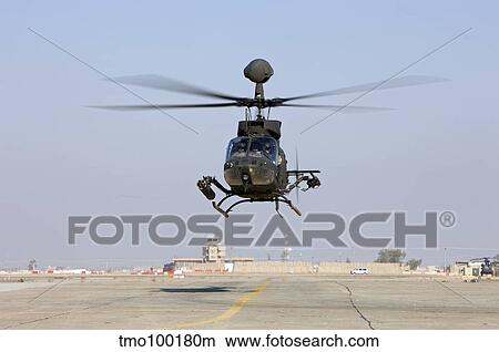 An OH-58D Kiowa Warrior hovers over the flight line at Camp Speicher, Iraq. View Large Photo Image Picture - An OH-58D Kiowa Warrior hovers over the flight line at Camp Speicher, Iraq.. Fotosearch
