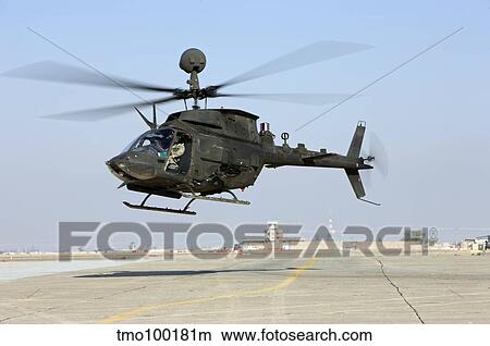 An OH-58D Kiowa Warrior hovers over the flight line at Camp Speicher, Iraq. View Large Photo Image Picture - An OH-58D Kiowa Warrior hovers over the flight line at Camp Speicher, Iraq.. Fotosearch
