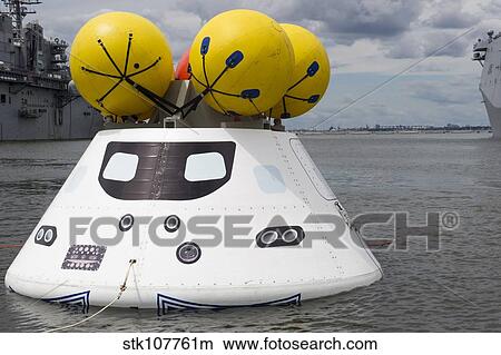 An Orion capsule before being towed into the well deck of USS Arlington. View Large Photo Image Picture - An Orion capsule before being towed into the well deck of USS Arlington.. Fotosearch