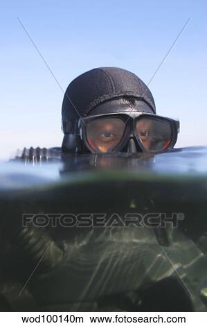 An over under view of a Navy SEAL combat swimmer. View Large Photo Image Picture - An over under view of a Navy SEAL combat swimmer.. Fotosearch
