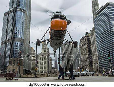 An S-58T helicopter comes down to street level in Chicago, Illinois. View Large Photo Image Picture - An S-58T helicopter comes down to street level in Chicago, Illinois.. Fotosearch