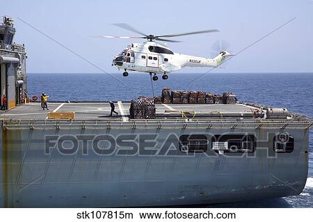 An SA-330J Puma helicopter delivers supplies to USS Kearsarge View Large Photo Image Picture - An SA-330J Puma helicopter delivers supplies to USS Kearsarge. Fotosearch
