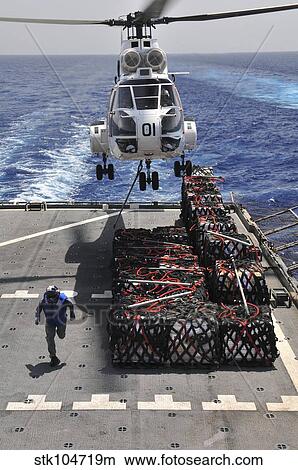 An SA-330J Puma helicopter picking up pallets of supplies from USNS Alan Shepard. View Large Photo Image Picture - An SA-330J Puma helicopter picking up pallets of supplies from USNS Alan Shepard.. Fotosearch