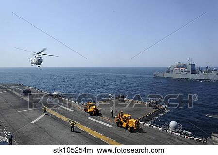 Picture - An SA330J Puma helicopter conducts vertical replenishement.. Fotosearch
