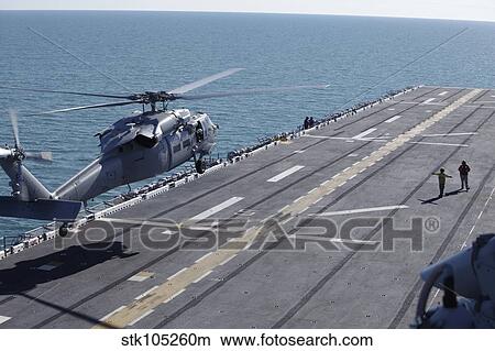 An SH-60 Sea Hawk helicopter lands aboard USS Kearsarge. View Large Photo Image Picture - An SH-60 Sea Hawk helicopter lands aboard USS Kearsarge.. Fotosearch