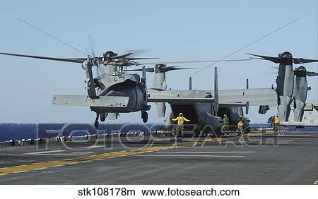 An SH-60 Sea Hawk lands on the flight deck aboard USS Bataan. View Large Photo Image Picture - An SH-60 Sea Hawk lands on the flight deck aboard USS Bataan.. Fotosearch