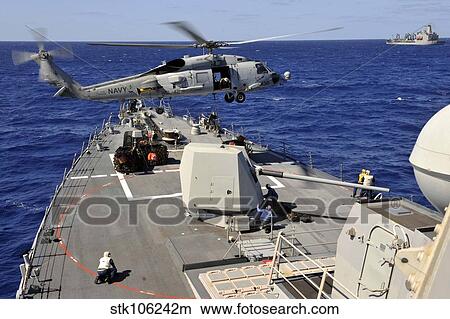 An SH-60B Sea Hawk helicopter picks up a pallet from USS Jason Dunham. View Large Photo Image Picture - An SH-60B Sea Hawk helicopter picks up a pallet from USS Jason Dunham.. Fotosearch