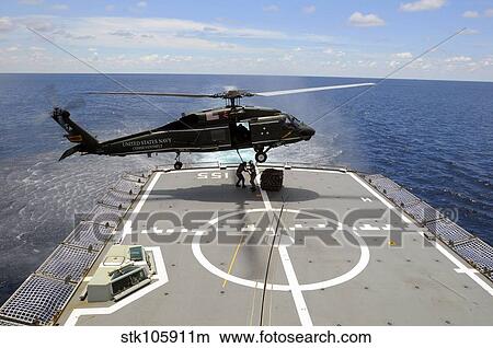 An SH-60F Sea Hawk helicopter lowers pallets onto HMAS Ballarat. View Large Photo Image Picture - An SH-60F Sea Hawk helicopter lowers pallets onto HMAS Ballarat.. Fotosearch