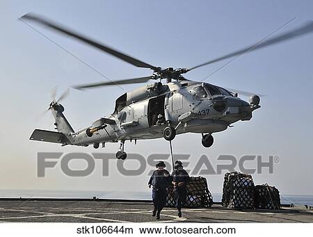 An SH-60F Sea Hawk helicopter picks up supplies from USS Gunston Hall. View Large Photo Image Picture - An SH-60F Sea Hawk helicopter picks up supplies from USS Gunston Hall.. Fotosearch
