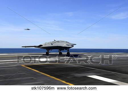 An X-47B unmanned combat air system conducts a touch and go landing. View Large Photo Image Picture - An X-47B unmanned combat air system conducts a touch and go landing.. Fotosearch