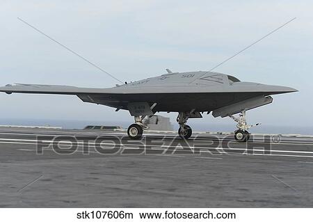 An X-47B unmanned combat air system conducts a touch and go landing. View Large Photo Image Picture - An X-47B unmanned combat air system conducts a touch and go landing.. Fotosearch