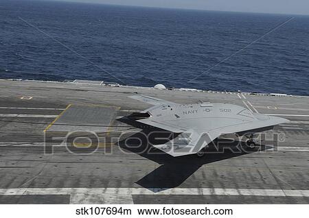 An X-47B Unmanned Combat Air System makes an arrested landing. View Large Photo Image Picture - An X-47B Unmanned Combat Air System makes an arrested landing.. Fotosearch