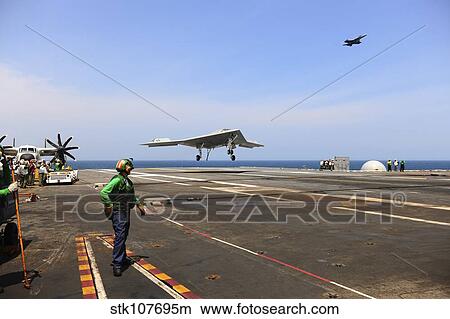An X-47B Unmanned Combat Air System makes an arrested landing. View Large Photo Image Picture - An X-47B Unmanned Combat Air System makes an arrested landing.. Fotosearch