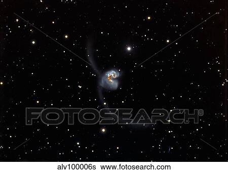 Stock Photograph - Antennae (NGC 4038 and 4039), interacting pair of galaxies in Corvus.. Fotosearch