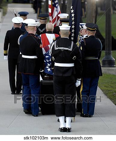 Armed Forces body bearers carry a casket to the internment sight. View Large Photo Image Picture - Armed Forces body bearers carry a casket to the internment sight.. Fotosearch