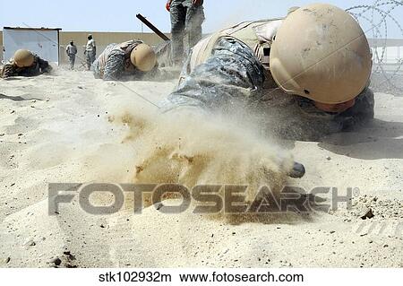 Army soldier pulls himself through a sandpit on a Defender Challenge course. View Large Photo Image Picture - Army soldier pulls himself through a sandpit on a Defender Challenge course.. Fotosearch