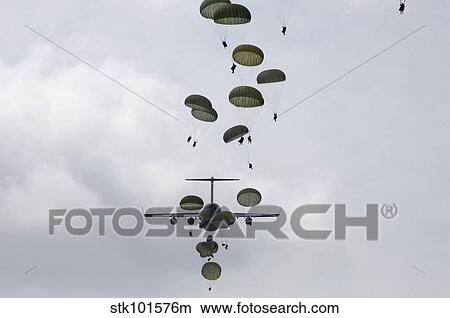Army Soldiers jump out of a C-17 Globemaster III. View Large Photo Image Picture - Army Soldiers jump out of a C-17 Globemaster III.. Fotosearch