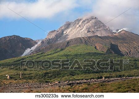 Stock Photograph - Ash and gas rising from lava dome of Soufriere Hills volcano, Montserrat, Caribbean.. Fotosearch