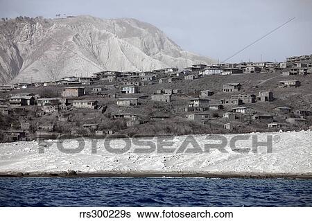 Stock Photograph - Ash-covered houses in abandoned city of Plymouth, Soufriere Hills Volcano, Montserrat, Caribbean.. Fotosearch