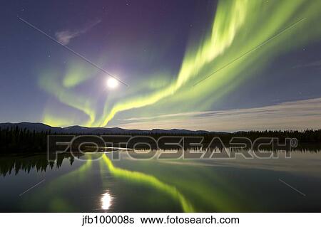 Stock Photograph - Aurora borealis and Full Moon over the Yukon River, Canada.. Fotosearch