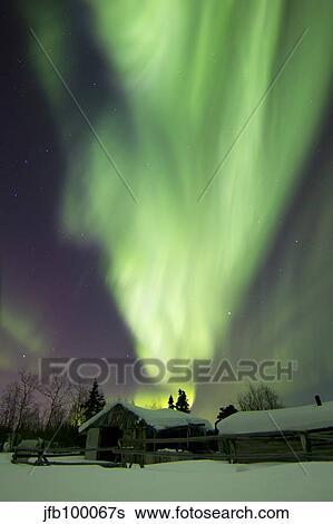 Aurora borealis and the Big Dipper above a log cabin at Whitehorse, Yukon, Canada. View Large Photo Image Stock Photograph - Aurora borealis and the Big Dipper above a log cabin at Whitehorse, Yukon, Canada.. Fotosearch