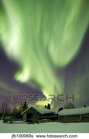 Aurora borealis and the Big Dipper above a log cabin at Whitehorse, Yukon, Canada. View Large Photo Image Stock Photograph - Aurora borealis and the Big Dipper above a log cabin at Whitehorse, Yukon, Canada.. Fotosearch