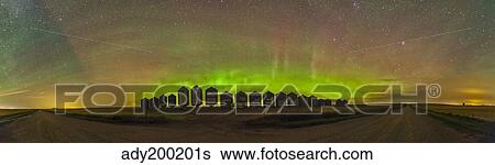 Aurora borealis behind grain bins on a country road in Alberta, Canada. View Large Photo Image Stock Photograph - Aurora borealis behind grain bins on a country road in Alberta, Canada.. Fotosearch