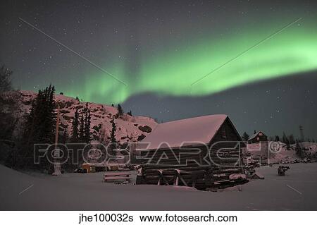 Stock Photograph - Aurora borealis over a cabin, Northwest Territories, Canada.. Fotosearch