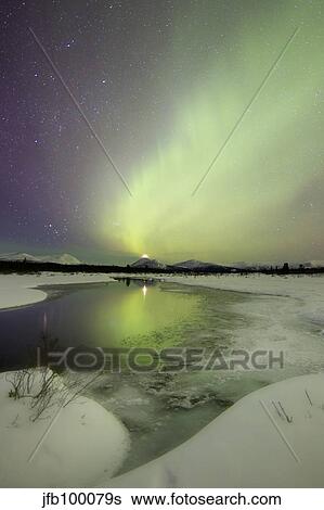 Aurora borealis over a creek by Fish Lake, Yukon, Canada. View Large Photo Image Stock Photograph - Aurora borealis over a creek by Fish Lake, Yukon, Canada.. Fotosearch