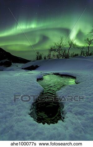 Aurora Borealis over a frozen river, Norway. View Large Photo Image Stock Photograph - Aurora Borealis over a frozen river, Norway.. Fotosearch