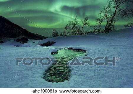 Aurora Borealis over a frozen river, Norway. View Large Photo Image Stock Photograph - Aurora Borealis over a frozen river, Norway.. Fotosearch
